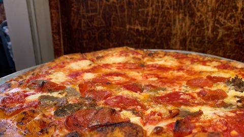 A sausage and pepperoni pizza from John's of Bleecker Street retains its crisp in spite of the heavy helping of meat.