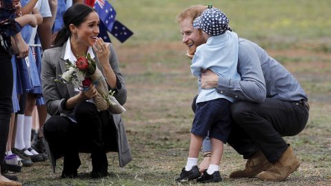 Britain's Prince Harry and Meghan, Duchess of Sussex are embraced by Luke Vincent, 5, on their arrival in Dubbo, Australia.