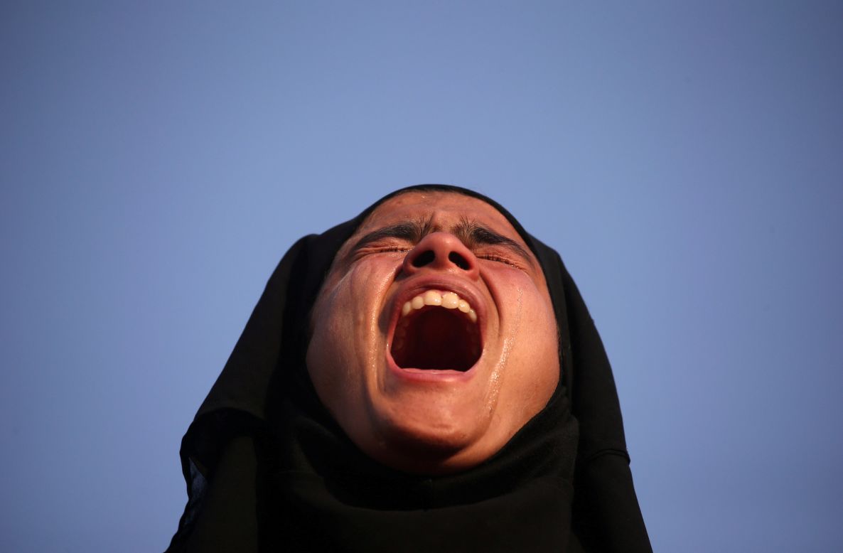 A girl cries as she watches the funeral procession of Mehraj ud Din Bangroo in Srinagar, India, on Wednesday, October 17. Bangroo was a suspected militant who was killed in a gunbattle with Indian security forces.  