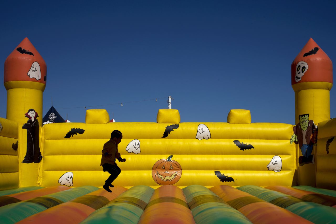 A boy plays in the bounce house at a pumpkin patch in Seal Beach, California, on Tuesday, October 9. 