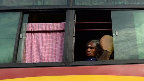 A Hindu devotee looks out from a shuttle bus going to the temple.