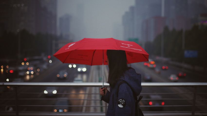 A pedestrian walks on a footbridge in heavy smog in Beijing, China, 15 October 2018. Most urban districts of the Chinese capital and other parts of northern China have been hit by smog which sent the air pollution index to "hazardous" levels in cities like Baoding and Shijiazhuang on Monday (Oct 15). It is the third day in a row that the region has been blanketed with smog. The pollution is expected to reach its peak on Monday (Oct 15), and some parts of south-east Beijing will see heavy air pollution, reported Beijing Youth Daily on Sunday evening, citing the Beijing Environmental Monitoring Centre.  (Imaginechina via AP Images)