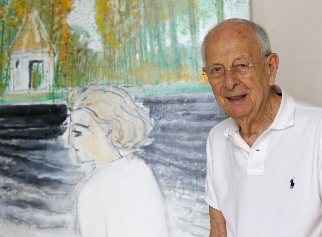 Brasilier posing next to a painting of his wife, Chantal, who is another of his inspirations. 