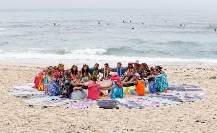 Harry and Meghan talk with members of OneWave, an awareness group for mental health and well-being, at Bondi Beach, Sydney.