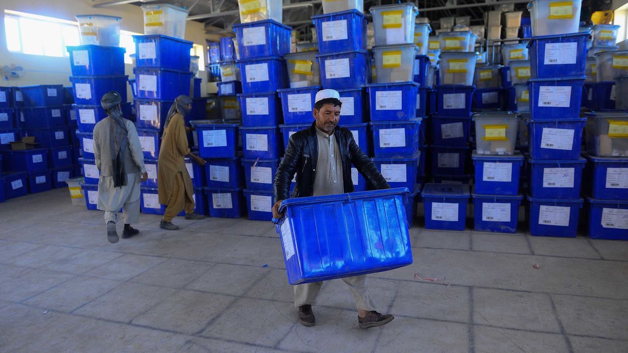 Afghan employees of the Independent Election Commission carry ballot boxes at a warehouse in Herat province on Wednesday.