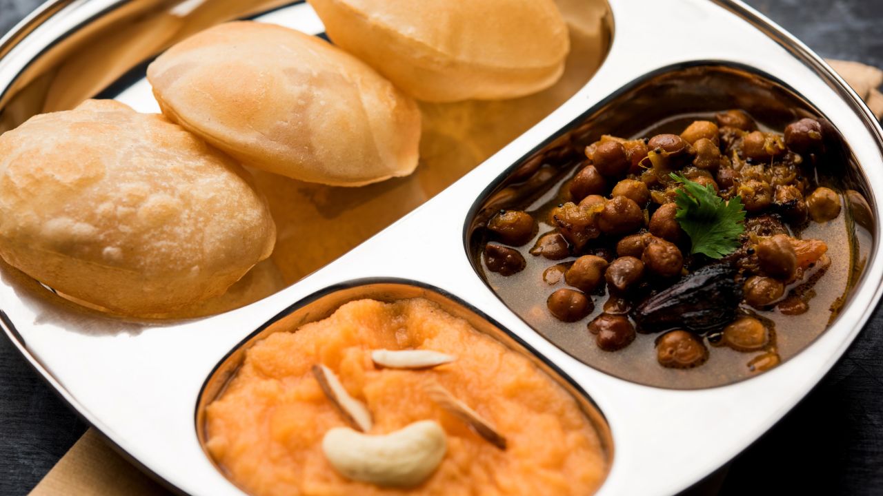 <strong>Halwa poori and channa</strong>: Often eaten on Eid morning, this breakfast combines poori (deep-fried bread), halwa (made with wheat semolina, sugar and butter) and channa (a chickpea curry).