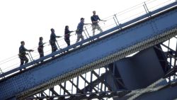 Scott Morrison MP (2nd R) and Prince Harry, Duke of Sussex (R) climb the Sydney Harbour Bridge to officially raise the Invictus Flag, celebrating the arrival of the Invictus Games to Sydney on October 19, 2018 in Sydney, Australia.