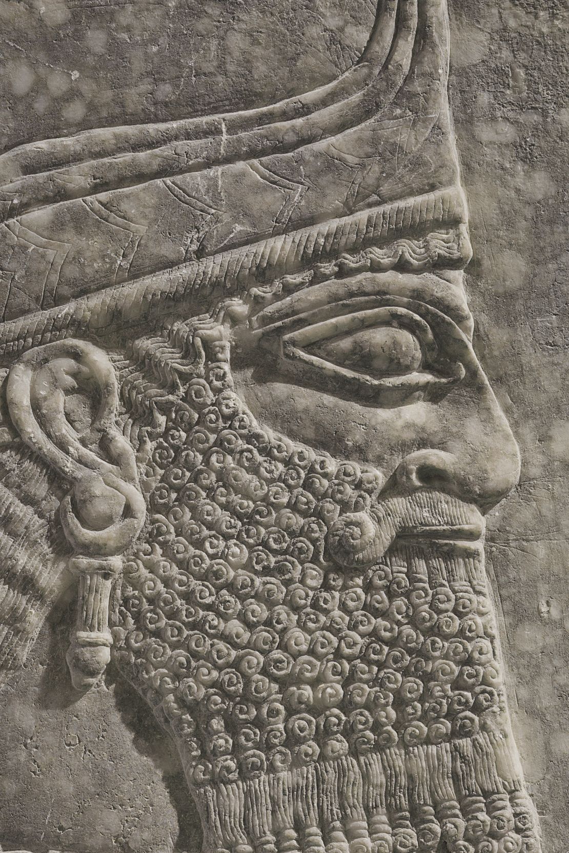 The bearded winged genius bears a striking resemblance to King Ashurnasirpal II.