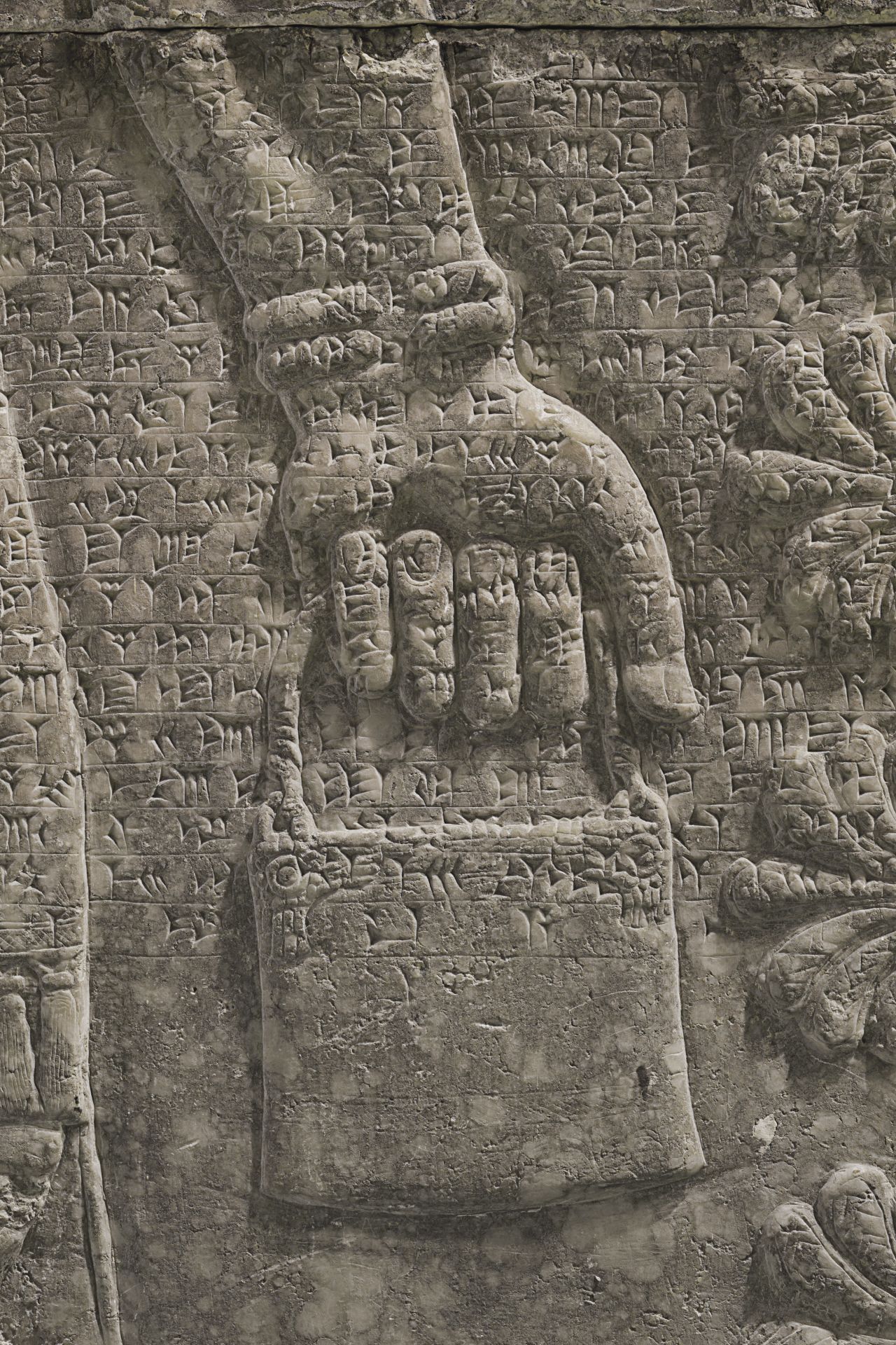 The winged genius carries a bucket-shaped vessel known as a situla in his left hand. 