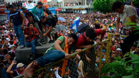 Thousands of Honduran migrants rush across the border toward Mexico, in Tecun Uman, Guatemala, Friday, October 19.