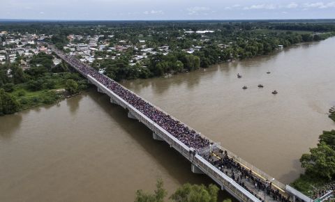 An aerial view shows a Honduran migrant caravan heading to the United States as it is stopped at a border barrier on the Guatemala-Mexico international bridge in Ciudad Hidalgo, Mexico, on Friday, October 19. 