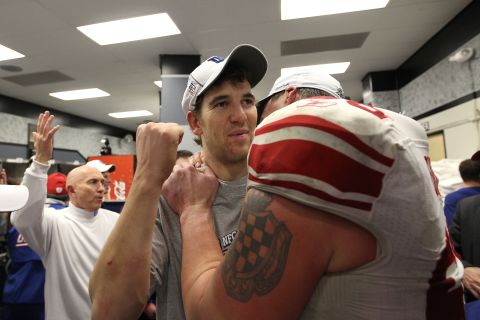 Eli Manning (left) and David Diehl of the New York Giants embrace in the locker room after they won in overtime game against the San Francisco 49ers during the NFC Championship Game at Candlestick Park on January 22, 2012. 