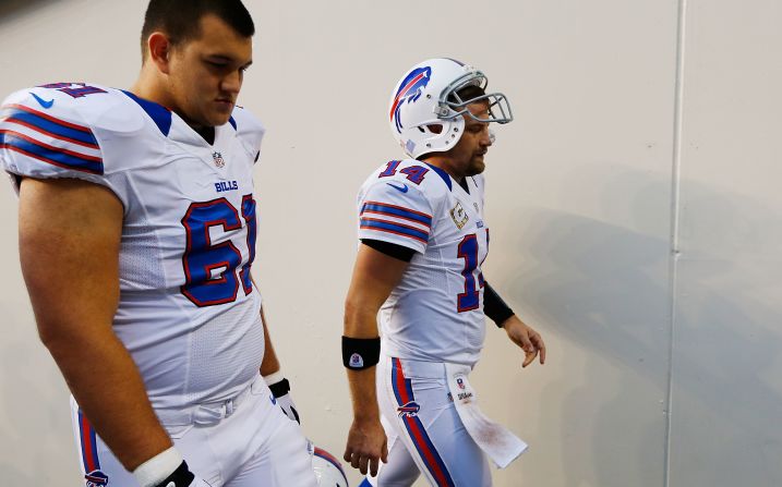 Buffallo Bills quarterback Ryan Fitzpatrick (right) heads to the locker room after throwing an interception to the New England Patriots to end a game on November 11, 2012 at Gillette Stadium in Foxboro, Massachusetts. He is pictured with teammate David Snow. 