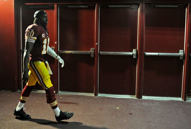 Quarterback Robert Griffin III of the Washington Redskins walks to the locker room after losing a close home game to the Philadelphia Eagles at FedEx Field on September 9, 2013.