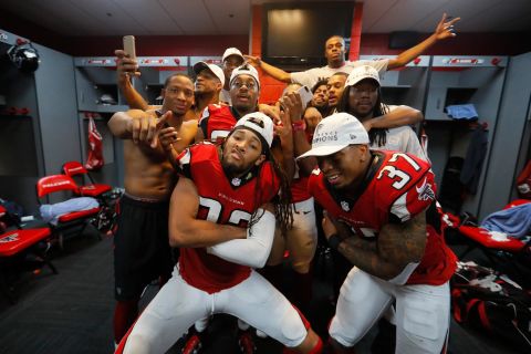 Jalen Collins #32 and Ricardo Allen #37 of the Atlanta Falcons strike a pose with teammates in the locker room after defeating the Green Bay Packers in the NFC Championship Game at the Georgia Dome on January 22, 2017 in Atlanta, Georgia.