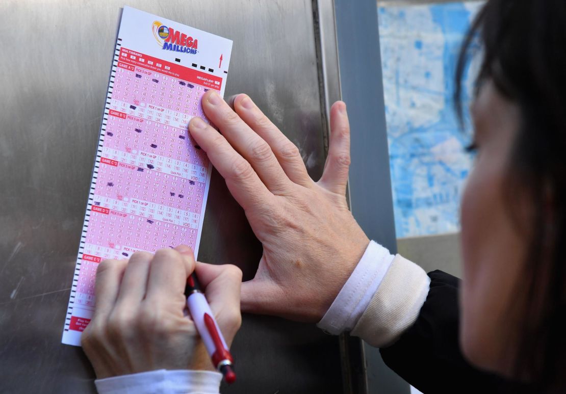A woman fills out a Mega Millions lottery ticket in New York  on Friday. 