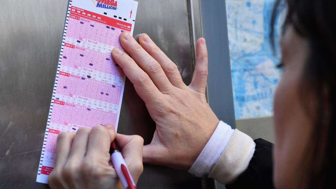 A woman fills out a Mega Millions lottery ticket in New York  on Friday. 