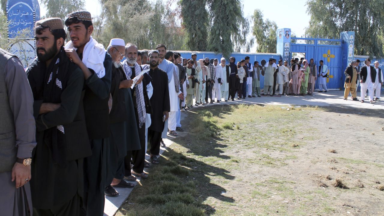 Afghan men line up to cast votes Saturday in Helmand province.