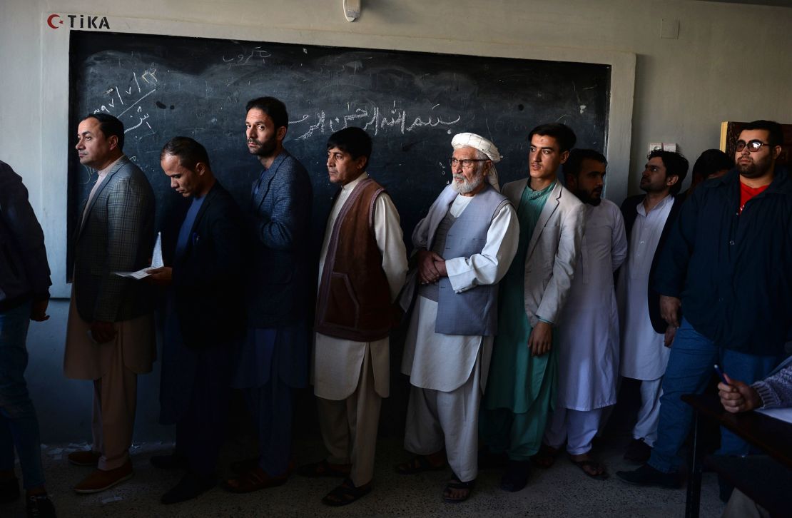 Afghan men line up to cast their vote at a polling center in Mazar-i-Sharif on Saturday.