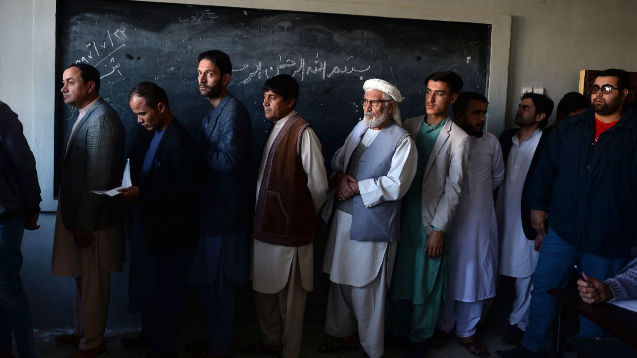 Afghan men line up to cast their vote at a polling center in Mazar-i-Sharif on Saturday.