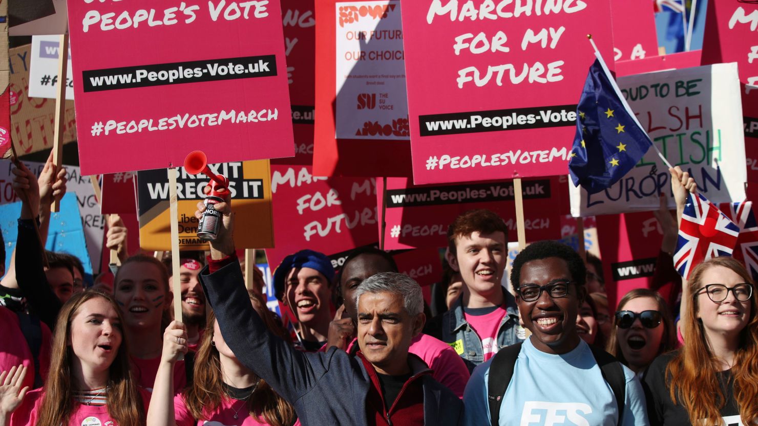 London Mayor Sadiq Khan, front center, holds a klaxon horn as he joins protesters in the People's Vote March for the Future on Saturday.