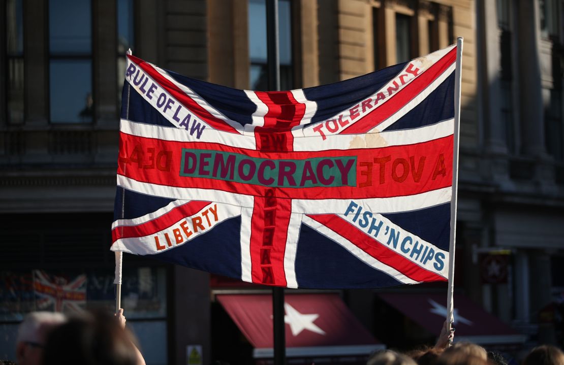 A British Union flag is held aloft during the march through London on Saturday.