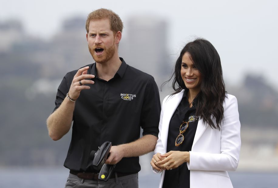 Meghan, Duchess of Sussex, watches as Prince Harry operates a remote-control car at the Invictus Games driving challenge on Saturday, on Cockatoo Island in Sydney.