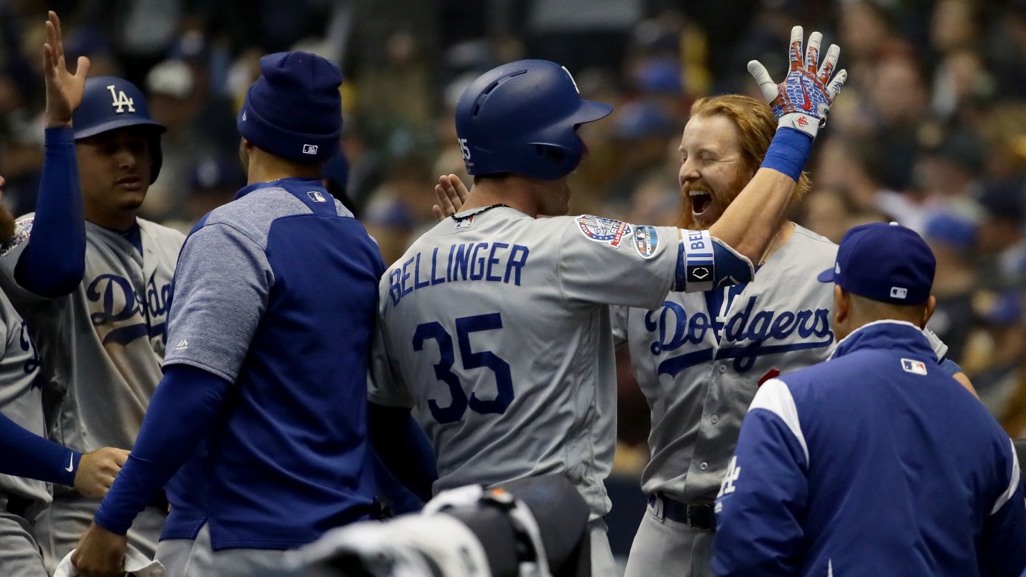 Cody Bellinger, No. 35 of the Los Angeles Dodgers, celebrates with his teammates after hitting a two-run home run Saturday night as the Dodgers headed to a 5-1 win over the Milwaukee Brewers to win the National League Championship.