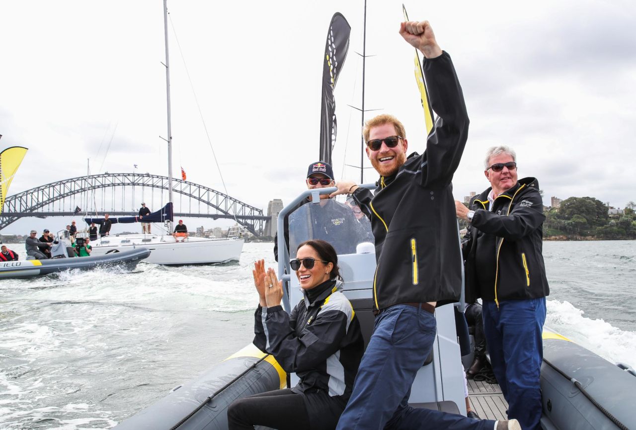 Harry and Meghan cheer on sailors during day two of the Invictus Games in Sydney on Sunday.