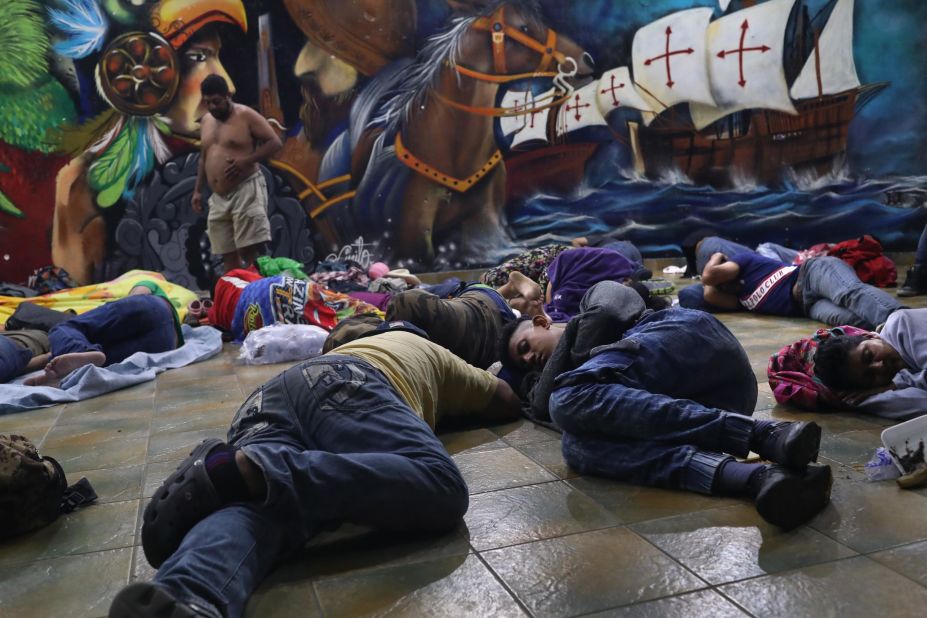 Migrants still on the Guatemalan side of the border sleep at a temporary immigrant shelter on Sunday in Ciudad Tecun Uman, Guatemala. The caravan of thousands of Central Americans made its way into Mexico with some members hoping to eventually reach the United States.