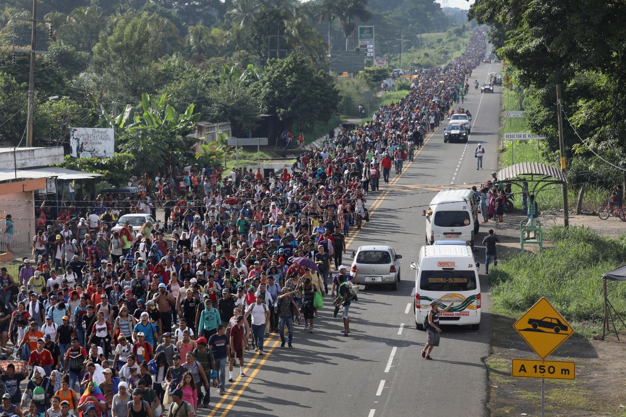 A migrant caravan headed to the United States walks into Mexico after crossing the Guatemalan border on Sunday, October 21. 