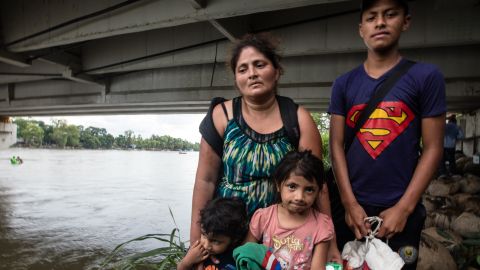 The Guillermo family pose for a photo, moments after reaching Mexico. Rosalin stands with her son Miner, 16, three-year-old Carlitos and Candy, 5.