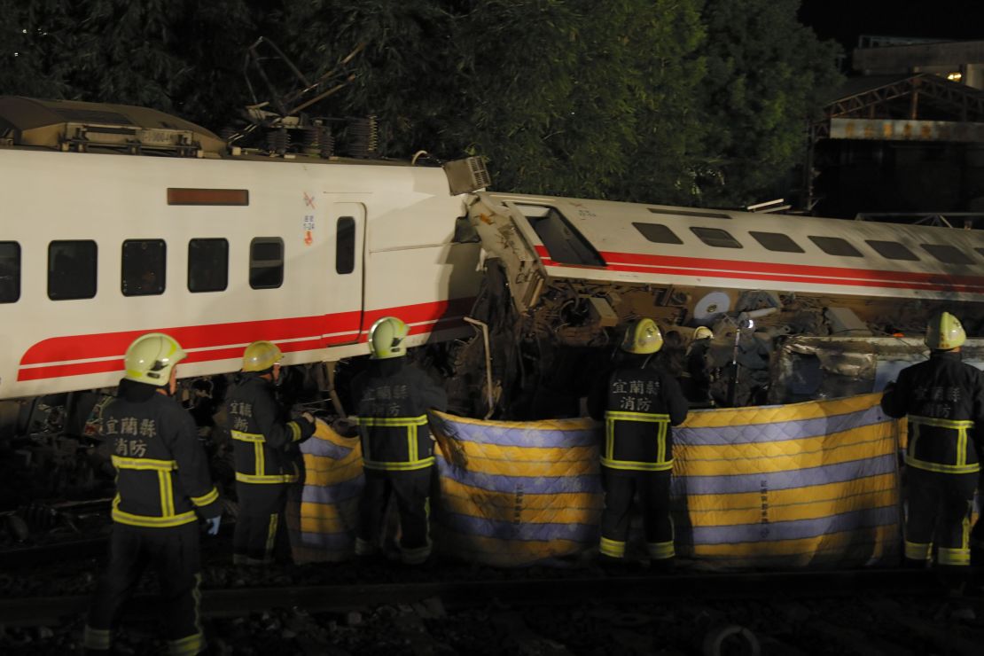 Rescue workers attend the scene after the Puyuma Express train derailed near Xima station in Taiwan's northeastern Yilan county on October 21, 2018.