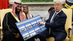 FILE - In this Tuesday, March 20, 2018 file photo, President Donald Trump holds a chart highlighting arms sales to Saudi Arabia during a meeting with Saudi Crown Prince Mohammed bin Salman in the Oval Office of the White House in Washington. (AP Photo/Evan Vucci)