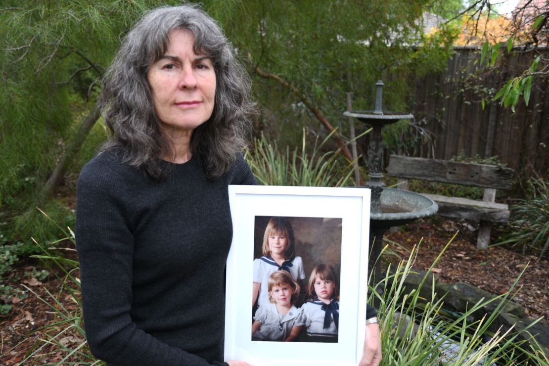 Advocate Chrissie Foster at home in Oakleigh, Melbourne, Australia in May. She's holding a picture of her three daughters Katie, Emma and Aimee. Katie and Emma were both abused by a local Catholic school priest.
