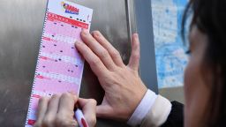 A woman fills out a Mega Millions lottery ticket on October 19, 2018, in New York City. 