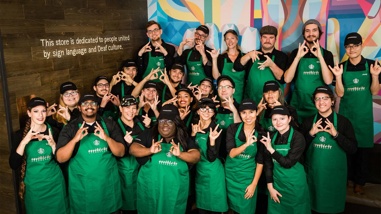 Baristas at the DC store sign "Starbucks."