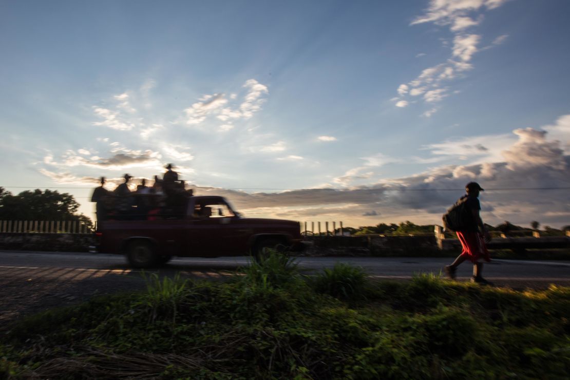A man walks along the road as the caravan of migrants leaves Tapachula in southern Mexico.