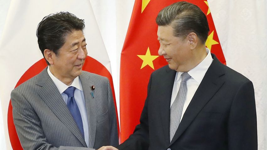 Japan's Prime Minister Shinzo Abe (L) shakes hands with China's President Xi Jinping (R) prior to their bilateral meeting in Vladivostok on September 12, 2018, on the sidelines of the Eastern Economic Forum hosted by Russia. (Photo by JIJI PRESS / Japan Pool via Jiji Press / AFP) / Japan OUT        (Photo credit should read JIJI PRESS/AFP/Getty Images)