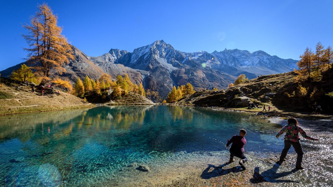 <strong>Arolla, Switzerland</strong>: In mid-October in Arolla, western Switzerland, visitors throw stones in the "Blue Lake." Algae and glacial clays colors the water this vivid blue. 