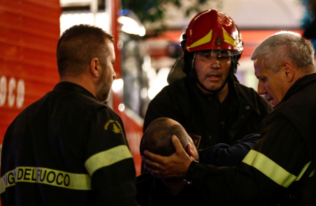 First responders tend to a wounded person on Piazza della Repubblica in central Rome.