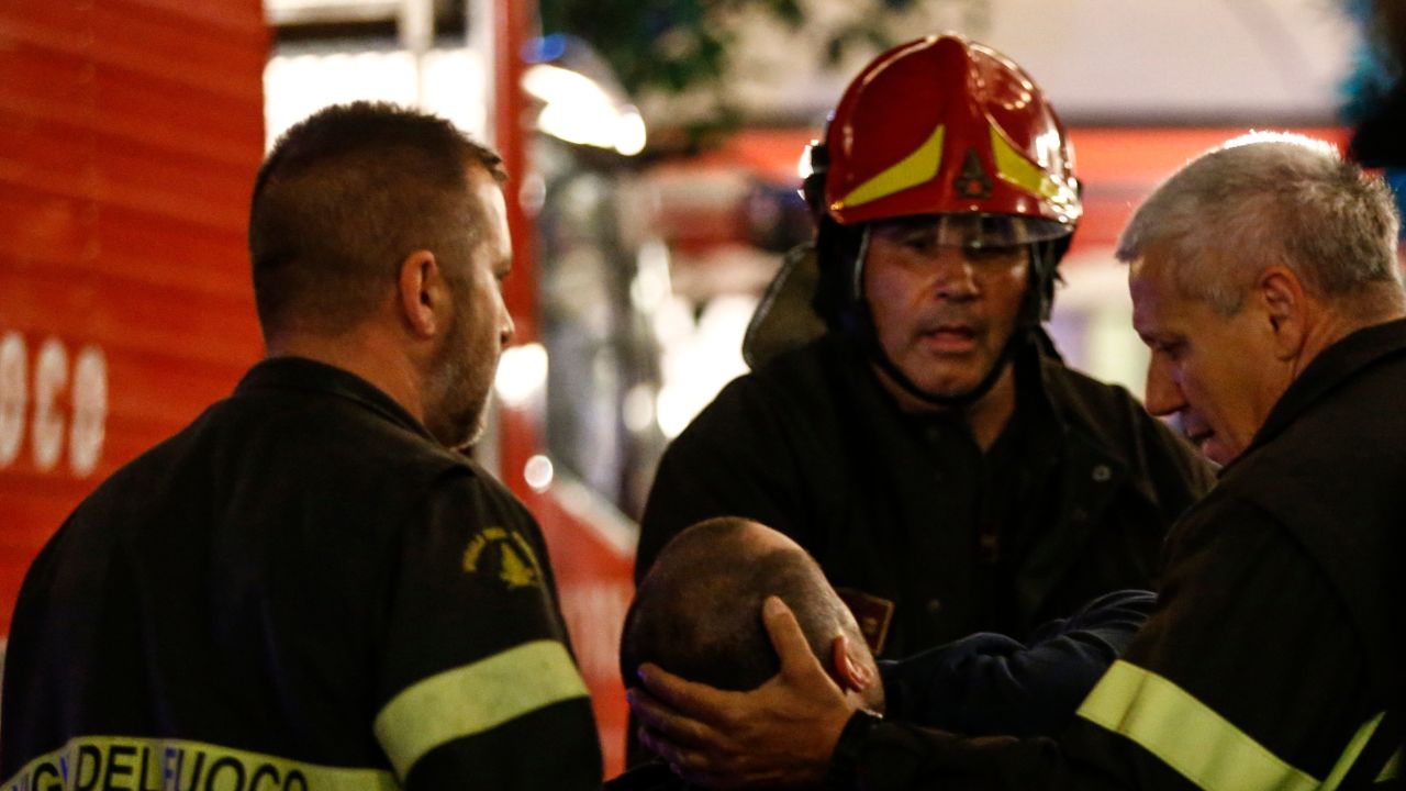 First responders tend to a wounded person on Piazza della Repubblica in central Rome.