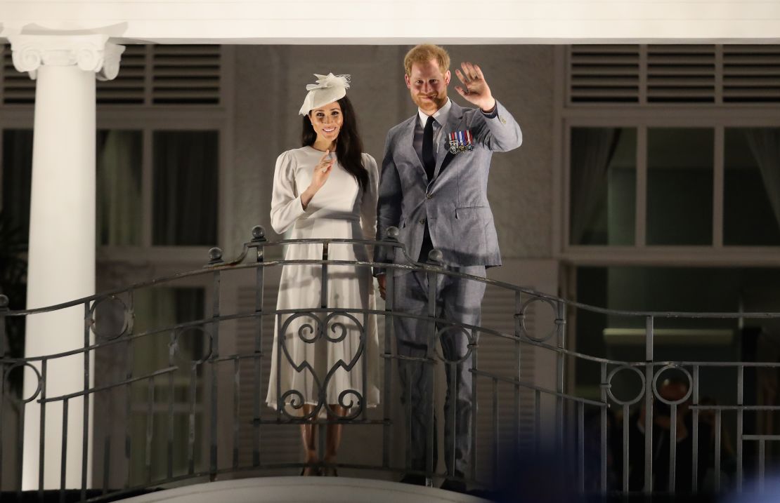 The royal couple wave from the balcony of the Grand Pacific Hotel in Suva.