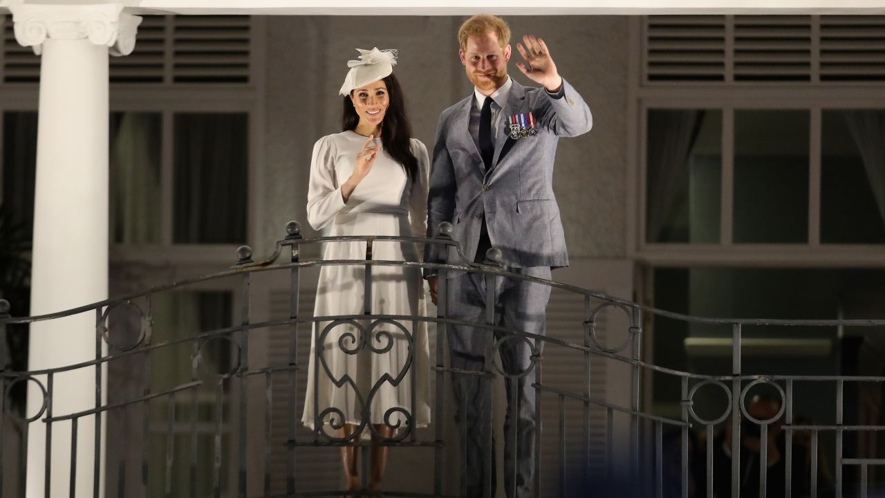The royal couple wave from the balcony of the Grand Pacific Hotel in Suva.