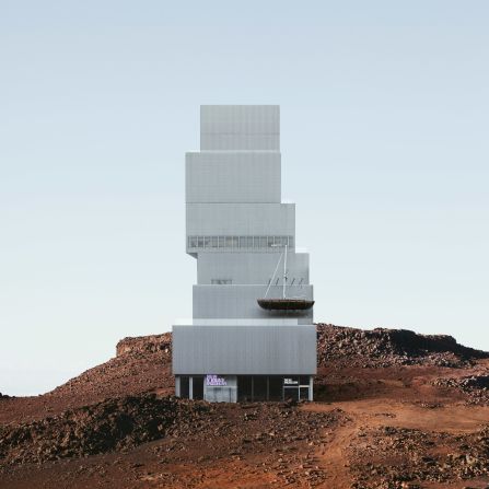 Six blocks stack to form the New Museum, which has been moved from the Lower East Side to a Mars-like terrain with rusty dust.