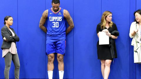 Mike Scott of the Los Angeles Clippers waits with staff members before a press conference last month. The Clippers are one of several NBA teams to employ women in top executive spots.  