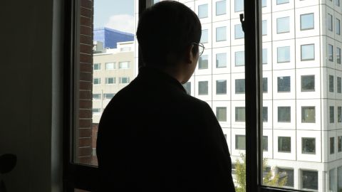 A man surnamed Hwang, a former Grace Road Church member, is seen looking out a window after speaking with CNN. CNN has agreed not to reveal his full identity due to fear of reprisals.