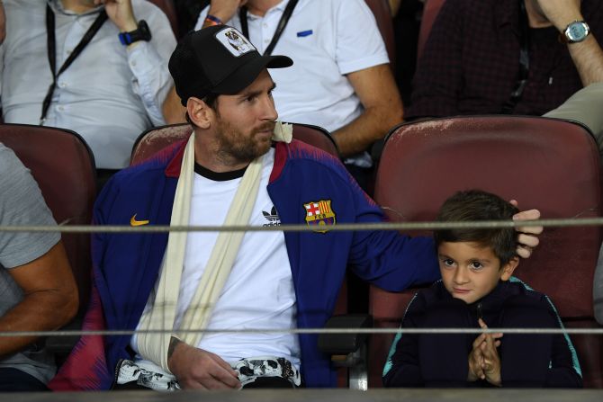 Lionel Messi watched his Barcelona side from the stands after fracturing his right arm at the weekend. The Catalan club announced that their star man, pictured here with his son, will likely miss three weeks of action. 