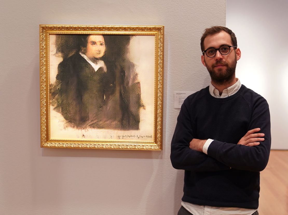 Pierre Fautrel, Co Founder of the team of French entrepreneurs which produces art using artificial intelligence, stands next to a work of art created by an algorithm. 