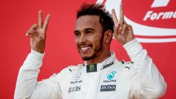 SUZUKA, JAPAN - OCTOBER 08:  Race winner Lewis Hamilton of Great Britain and Mercedes GP celebrates on the podium with a Mobot during the Formula One Grand Prix of Japan at Suzuka Circuit on October 8, 2017 in Suzuka.  (Photo by Lars Baron/Getty Images)
